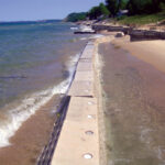 Waves crashing against Sandsaver Beach Erosion Barrier