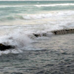 Waves Crashing Against Sandsavers in The Indian Ocean